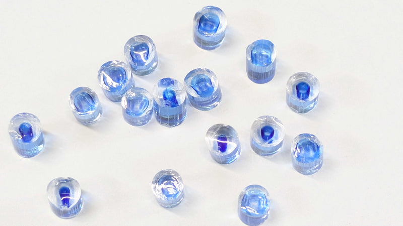 Set of blue plastic nuts on a white background